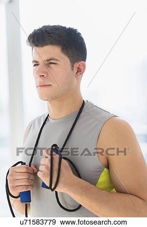 Stock Photo - Young man at gym. Fotosearch