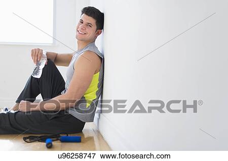 Stock Photo - Young man at gym. Fotosearch