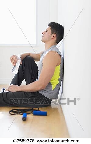 Stock Photograph - Young man at gym. Fotosearch