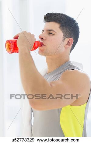 Stock Photo - Young man drinking sports drink. Fotosearch