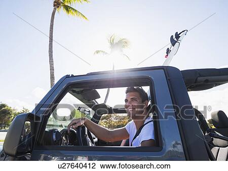 Young man driving car View Large Photo Image Stock Image - Young man driving car. Fotosearch