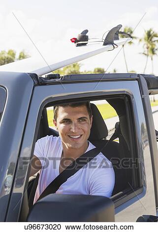 Young man driving car View Large Photo Image Stock Image - Young man driving car. Fotosearch