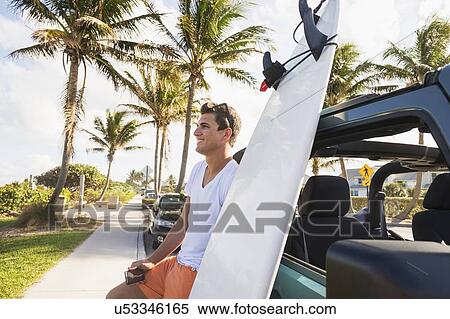 Young man holding mobile phone View Large Photo Image Stock Photography - Young man holding mobile phone. Fotosearch