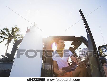 Young man using digital tablet View Large Photo Image Stock Photography - Young man using digital tablet. Fotosearch