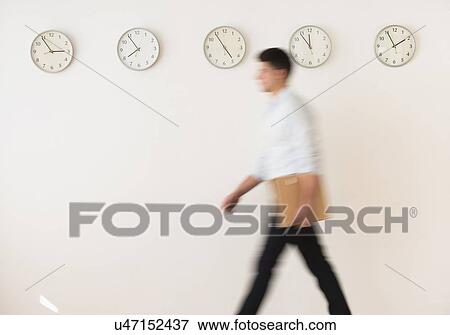 Stock Photo - Young man walking with envelope. Fotosearch