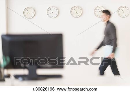 Stock Photograph - Young man walking with envelope. Fotosearch