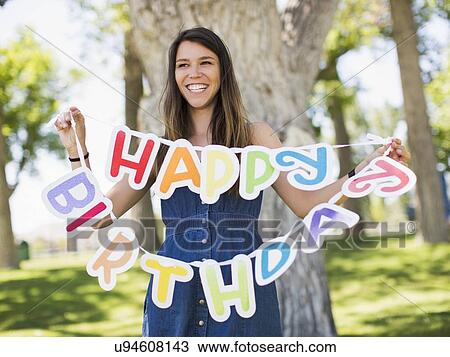 Young woman holding Happy birthday banner View Large Photo Image Stock Image - Young woman holding Happy birthday banner. Fotosearch