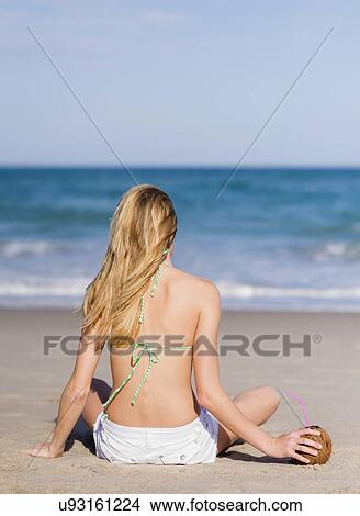 Young woman on beach View Large Photo Image Picture - Young woman on beach. Fotosearch