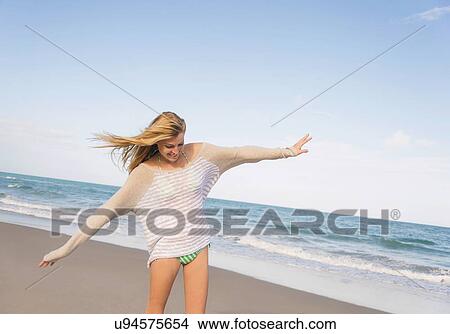Picture - Young woman on beach. Fotosearch