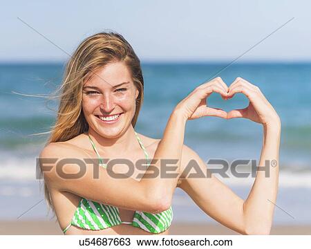 Young woman on beach View Large Photo Image Stock Image - Young woman on beach. Fotosearch