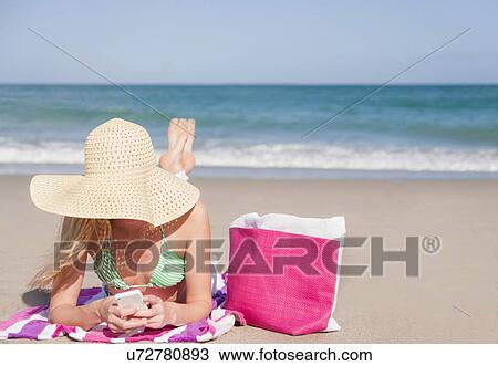 Young woman on beach View Large Photo Image Stock Image - Young woman on beach. Fotosearch