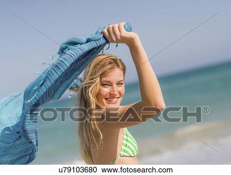 Stock Image - Young woman on beach. Fotosearch