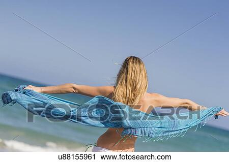 Stock Image - Young woman on beach. Fotosearch