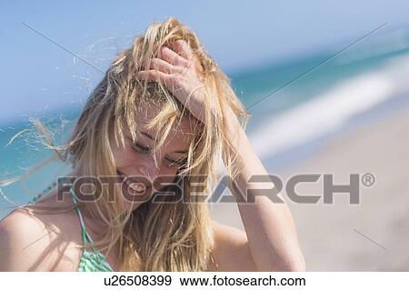 Stock Photo - Young woman on beach. Fotosearch