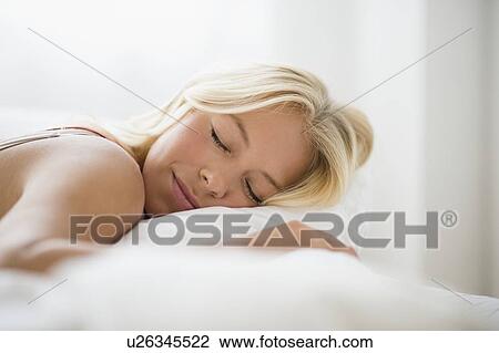 Stock Image - Young woman sleeping. Fotosearch