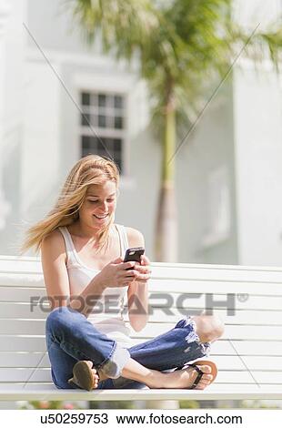 Young woman using mobile phone View Large Photo Image Stock Image - Young woman using mobile phone. Fotosearch