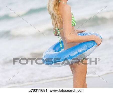 Young woman with inner tube View Large Photo Image Stock Image - Young woman with inner tube. Fotosearch