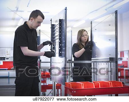 Apprentices on production line in training facility View Large Photo Image Stock Photo - Apprentices on production line in training facility. Fotosearch