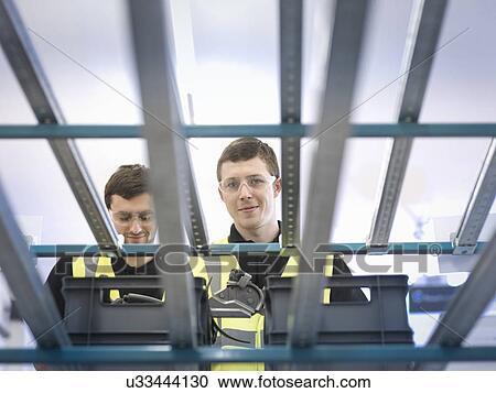 Apprentices on production line picking parts View Large Photo Image Stock Image - Apprentices on production line picking parts. Fotosearch