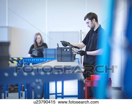 Stock Photography - Apprentices working on training production line. Fotosearch