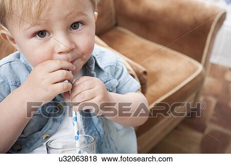 Stock Photo - Baby boy drinking milk. Fotosearch