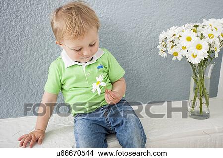 Baby boy playing with flowers View Large Photo Image Picture - Baby boy playing with flowers. Fotosearch