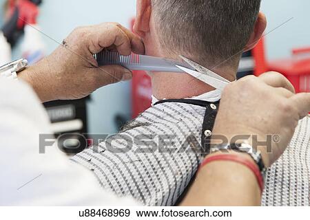 Barber cutting man's hair View Large Photo Image Stock Photo - Barber cutting man's hair. Fotosearch