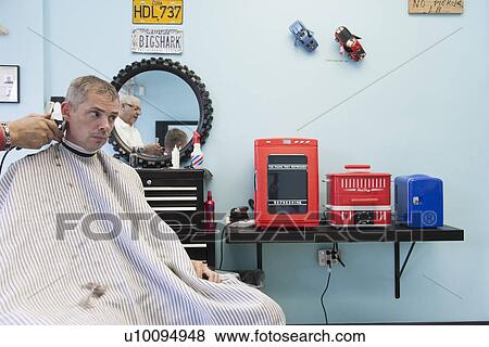 Barber shaving man's hair View Large Photo Image Stock Photo - Barber shaving man's hair. Fotosearch
