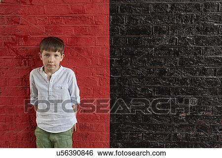 Boy against red and black wall View Large Photo Image Stock Photograph - Boy against red and black wall. Fotosearch