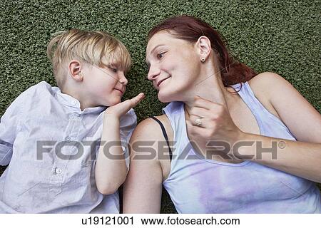 Stock Image - Boy blowing kiss to mother. Fotosearch