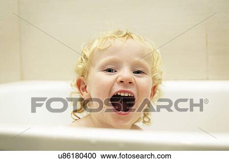 Stock Image - Boy playing in bath. Fotosearch