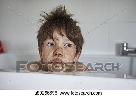 Boy with muddy face, sitting in bath View Large Photo Image Stock Photograph - Boy with muddy face, sitting in bath. Fotosearch