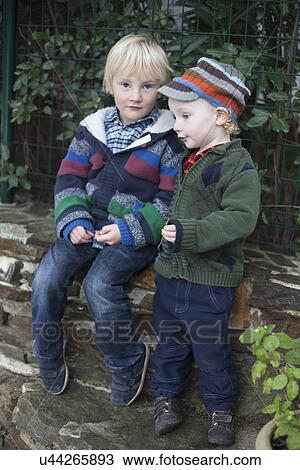 Stock Image - Brothers standing together, outdoors. Fotosearch