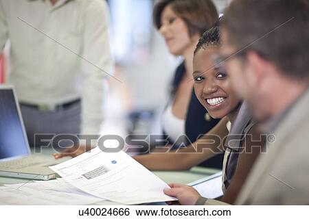 Stock Photograph - Business colleagues meeting in office. Fotosearch