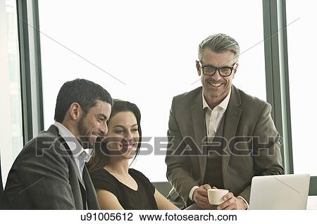 Business partners working together in office View Large Photo Image Stock Image - Business partners working together in office. Fotosearch