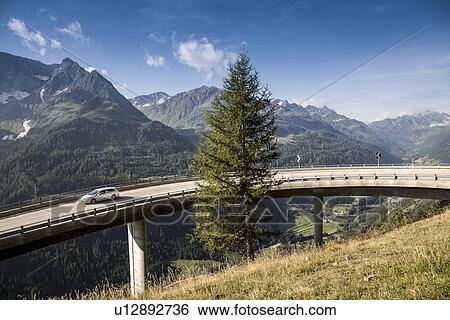 Car on elevated highway to Gotthard Pass, Switzerland View Large Photo Image Stock Photograph - Car on elevated highway to Gotthard Pass, Switzerland. Fotosearch