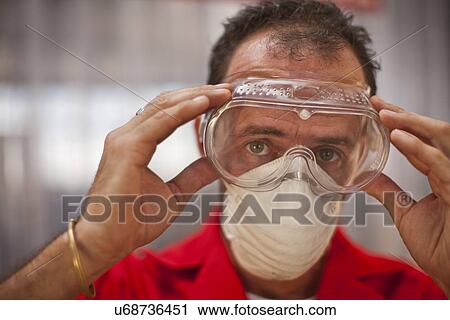 Carpenter putting on protective glasses View Large Photo Image Stock Image - Carpenter putting on protective glasses. Fotosearch