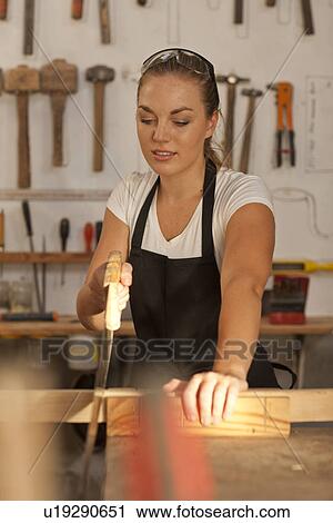 Carpenter sawing wood View Large Photo Image Stock Image - Carpenter sawing wood. Fotosearch