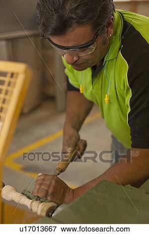 Carpenter turning wood with chisel in workshop View Large Photo Image Stock Photo - Carpenter turning wood with chisel in workshop. Fotosearch