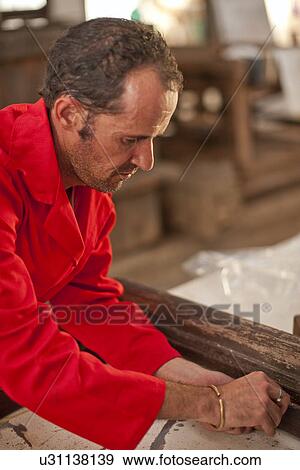Carpenter working on wooden frame View Large Photo Image Stock Photo - Carpenter working on wooden frame. Fotosearch