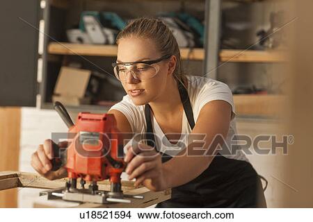 Picture - Carpenter working with power tools. Fotosearch