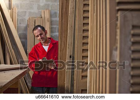Carpenter writing on clipboard View Large Photo Image Stock Image - Carpenter writing on clipboard. Fotosearch