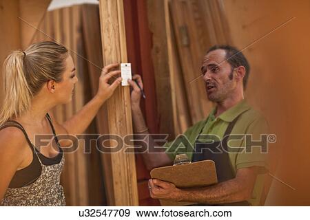 Stock Photo - Carpenters looking at piece of wood. Fotosearch