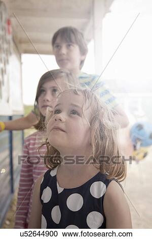 Children queueing and looking up in anticipation View Large Photo Image Stock Image - Children queueing and looking up in anticipation. Fotosearch