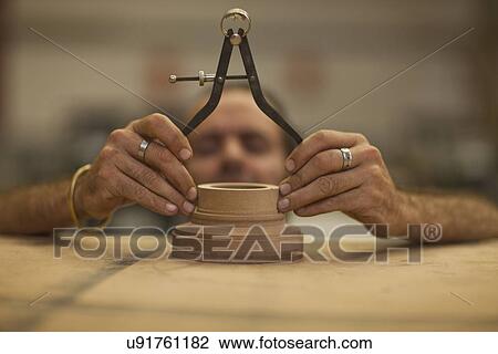 Close up of carpenter measuring turning wood in workshop View Large Photo Image Stock Image - Close up of carpenter measuring turning wood in workshop. Fotosearch