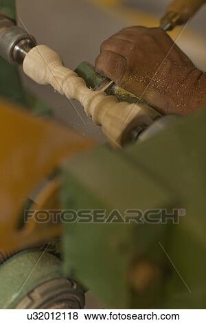 Close up of carpenter turning wood with chisel in workshop View Large Photo Image Stock Photo - Close up of carpenter turning wood with chisel in workshop. Fotosearch