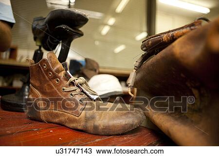 Stock Image - Close up of leather boot and bag. Fotosearch