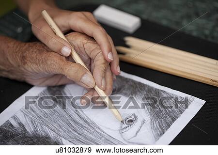 Close up of senior woman's hand doing a pencil drawing View Large Photo Image Stock Photo - Close up of senior woman's hand doing a pencil drawing. Fotosearch