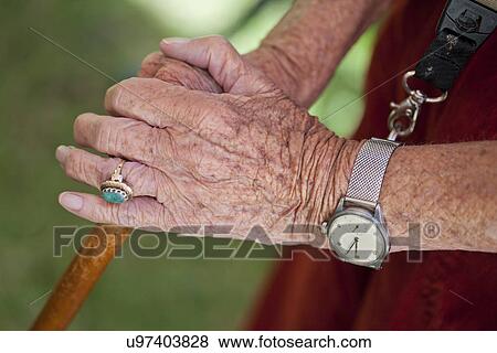Close up of senior woman's hands holding walking stick View Large Photo Image Stock Photo - Close up of senior woman's hands holding walking stick. Fotosearch