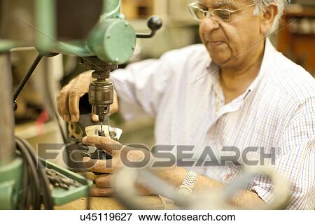 Stock Photo - Cobbler mending heel of shoe. Fotosearch